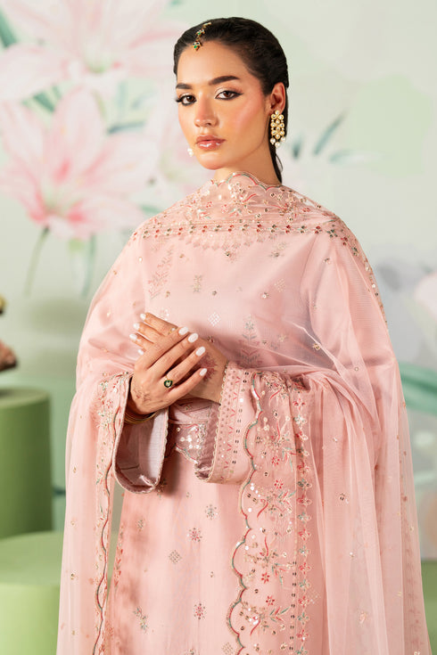 Woman wearing a pink embroidered traditional outfit with a floral background